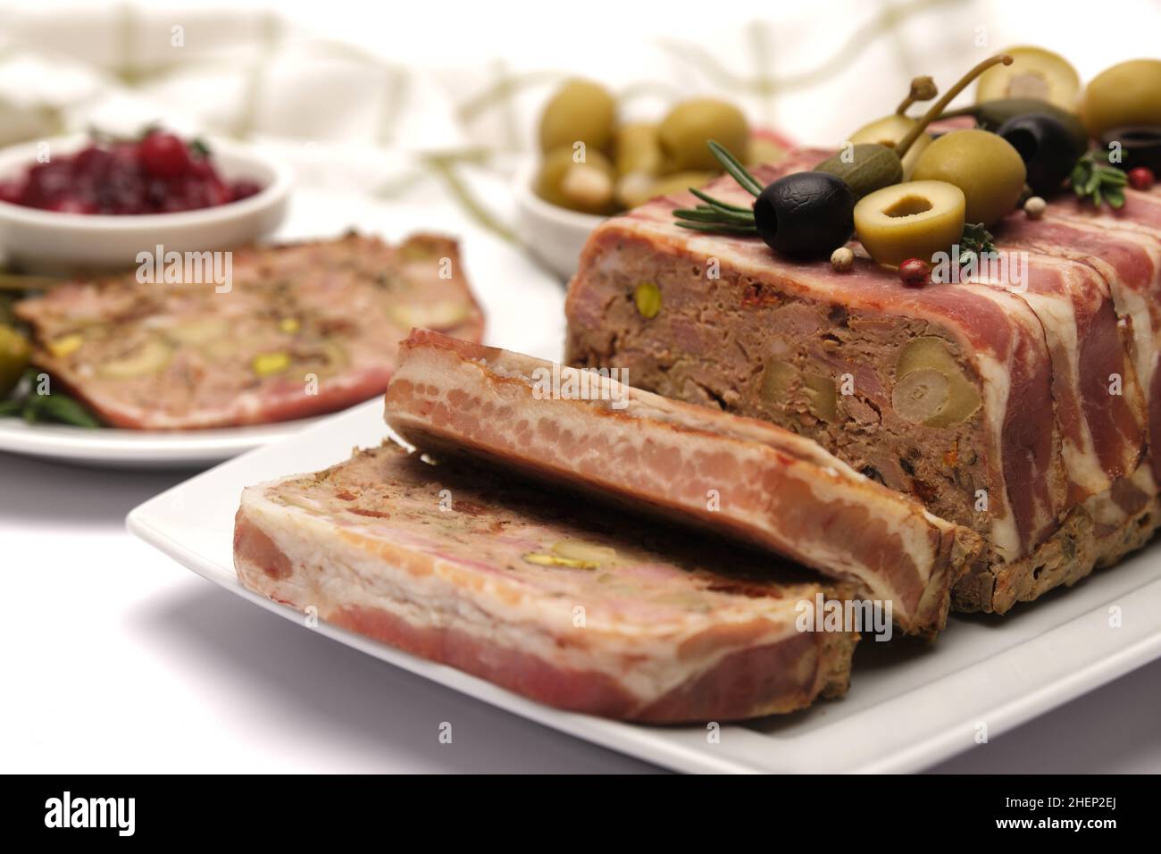 Traditional French terrine covered with bacon isolated on white