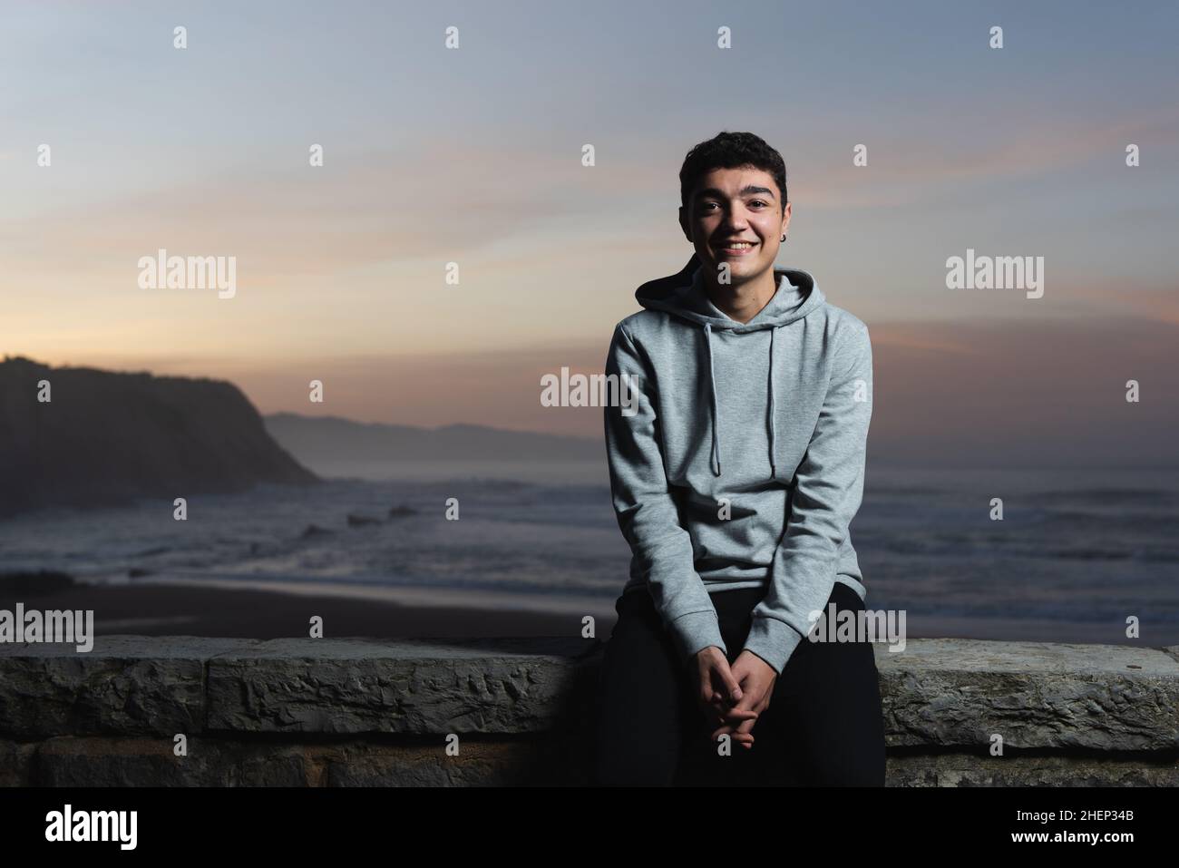 Happy hispanic teenager posing to the camera at sunset. Stock Photo