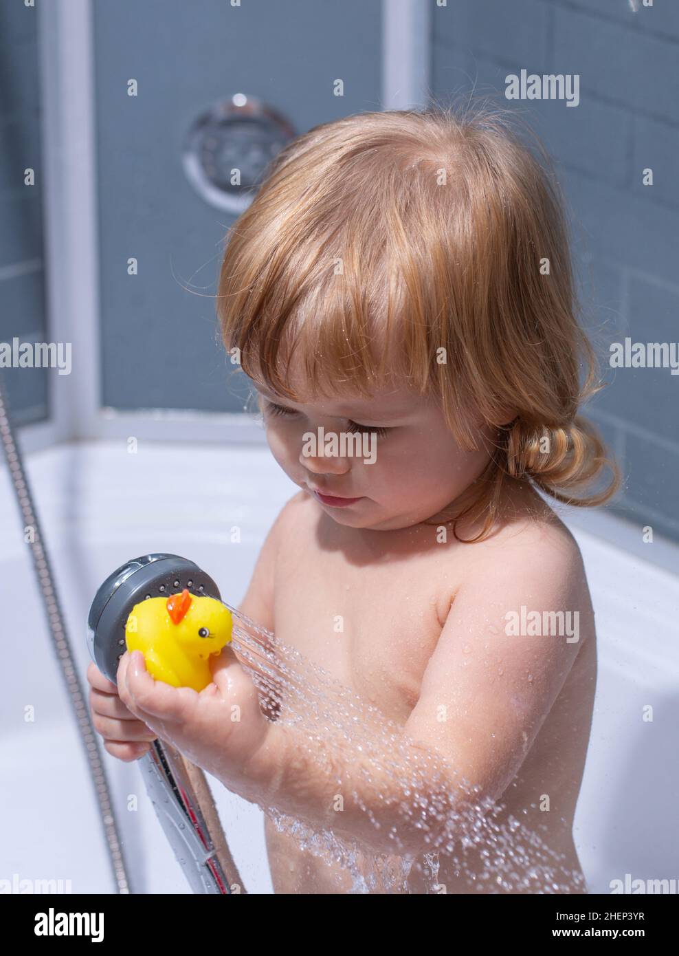 Baby showering. Portrait of kid bathing in a bath with foam Stock Photo