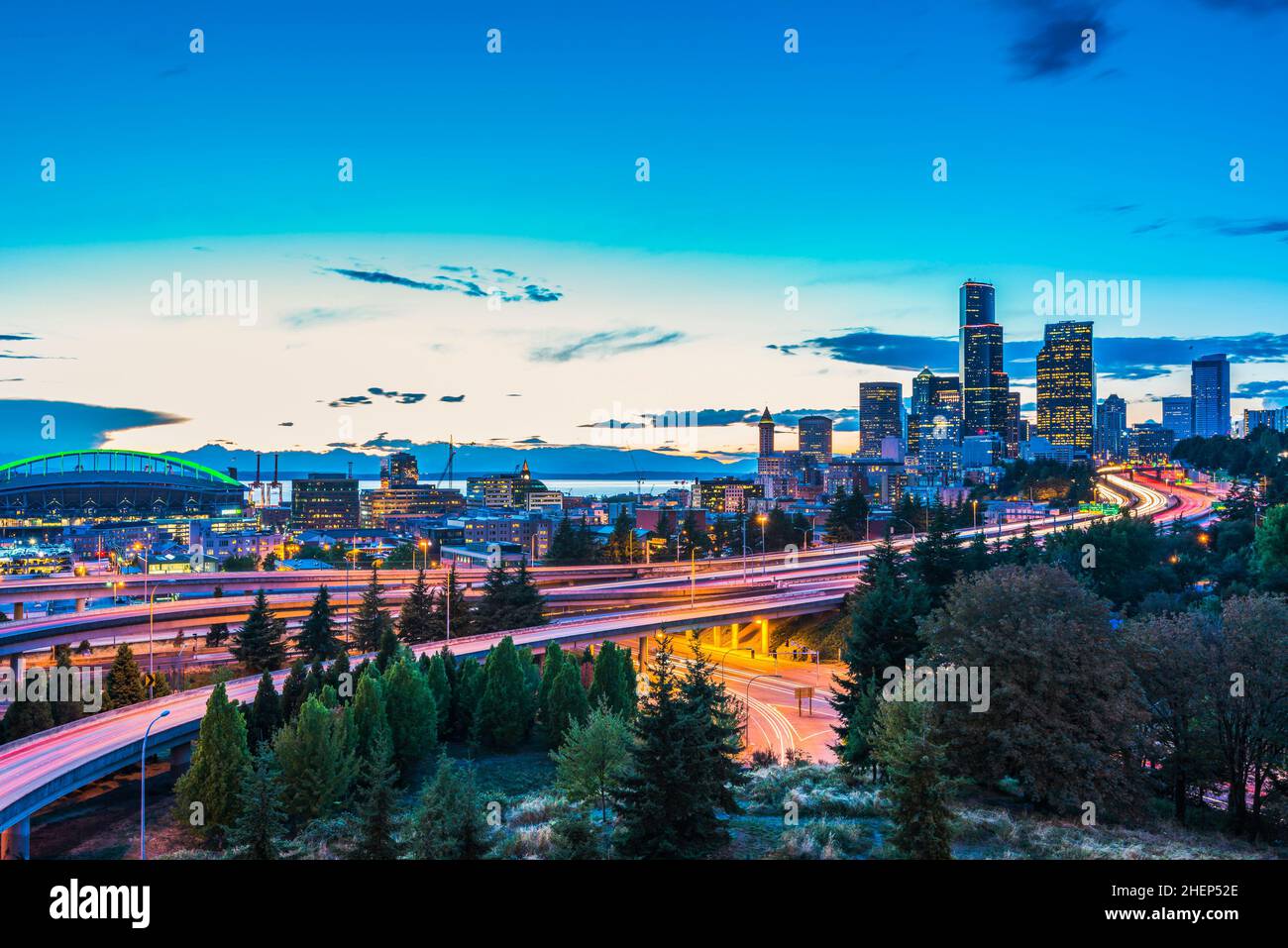 Seattle skylines and Interstate freeways converge at sunset, Seattle, Washington, USA. Stock Photo