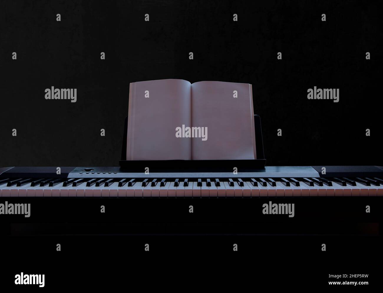 Electric piano with empty sheet music on black background piano