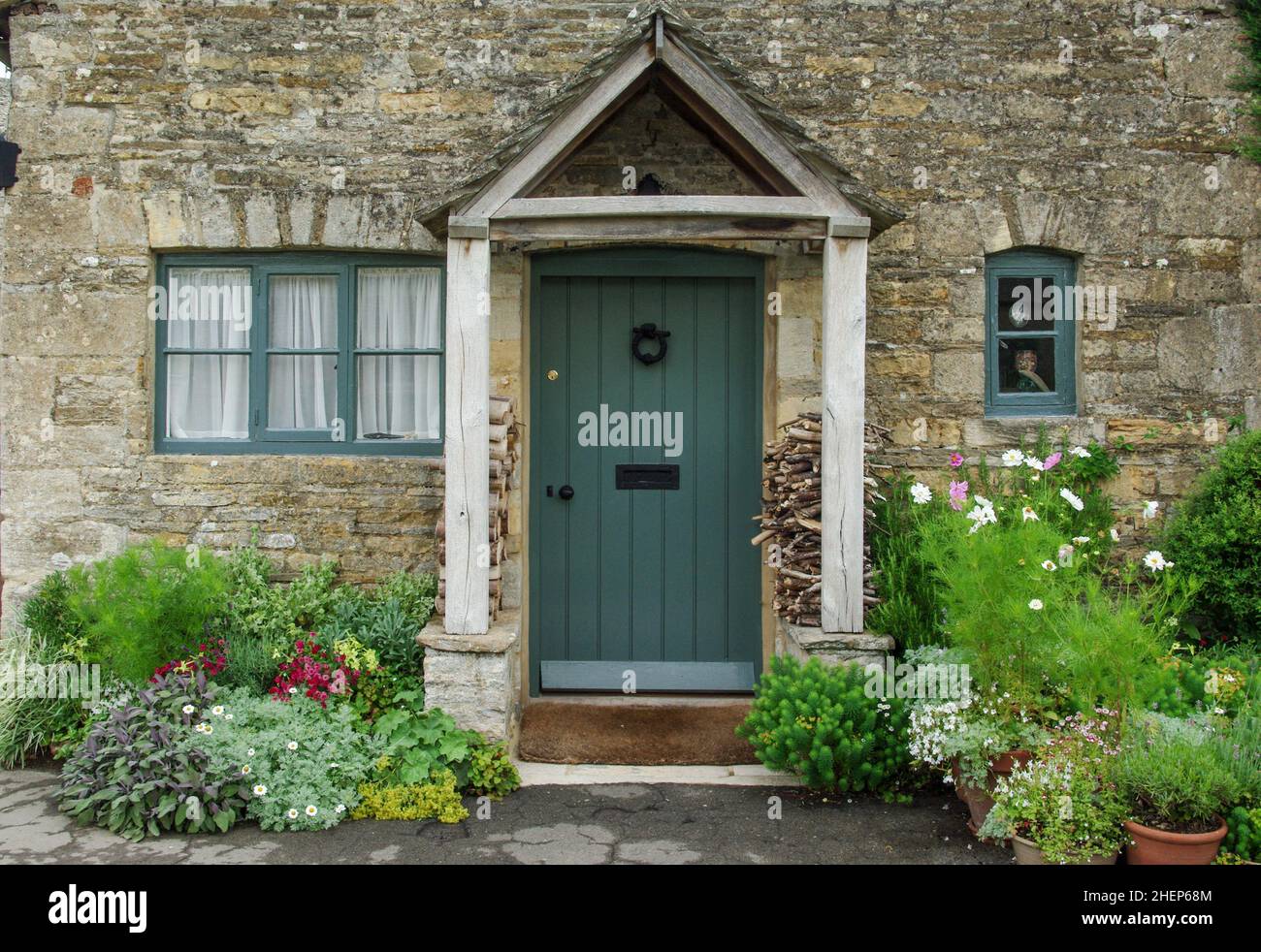 Blue front door and open porch on a stone built cottage in the Cotswold