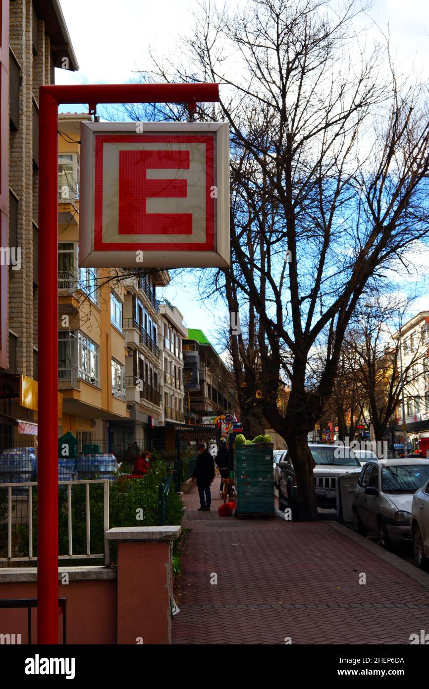 Red letter E of pharmacy signboard at street, pharmacy in Turkish-Eczane- Stock Photo