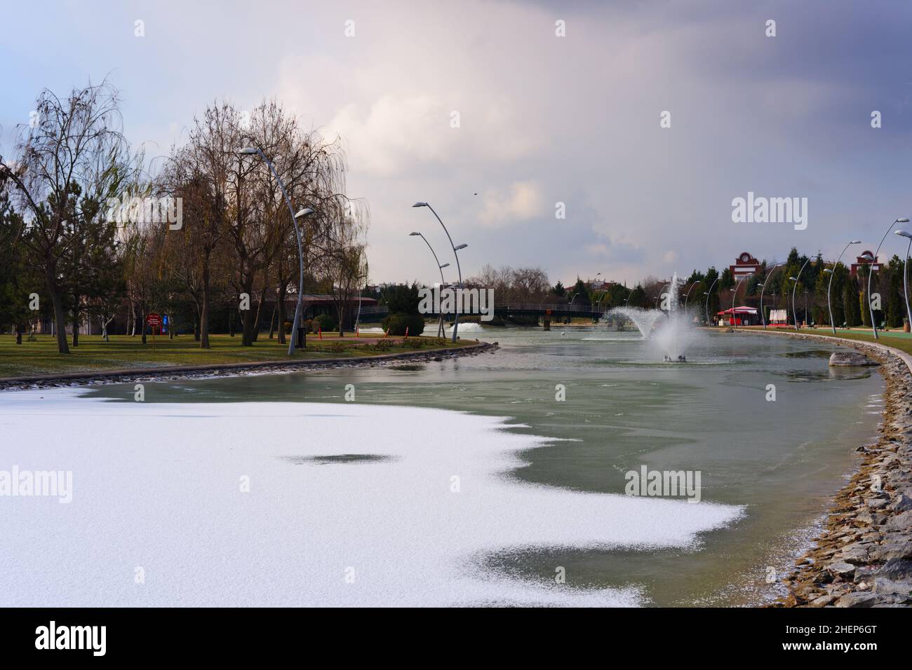 Partly frozen artificial lake and fountain at Eskisehir Kentpark Stock Photo