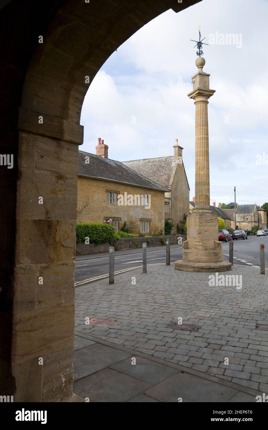The Market cross (also know as the Pinnacle monument) in Martock village centre, Somerset taken from an archway of the Market Hall Stock Photo