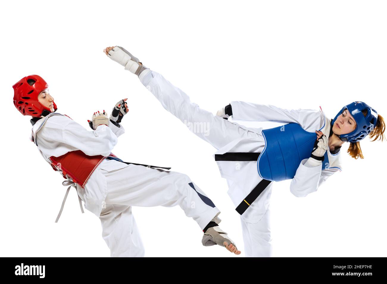 Portrait of two young women, taekwondo athletes practicing, fighting