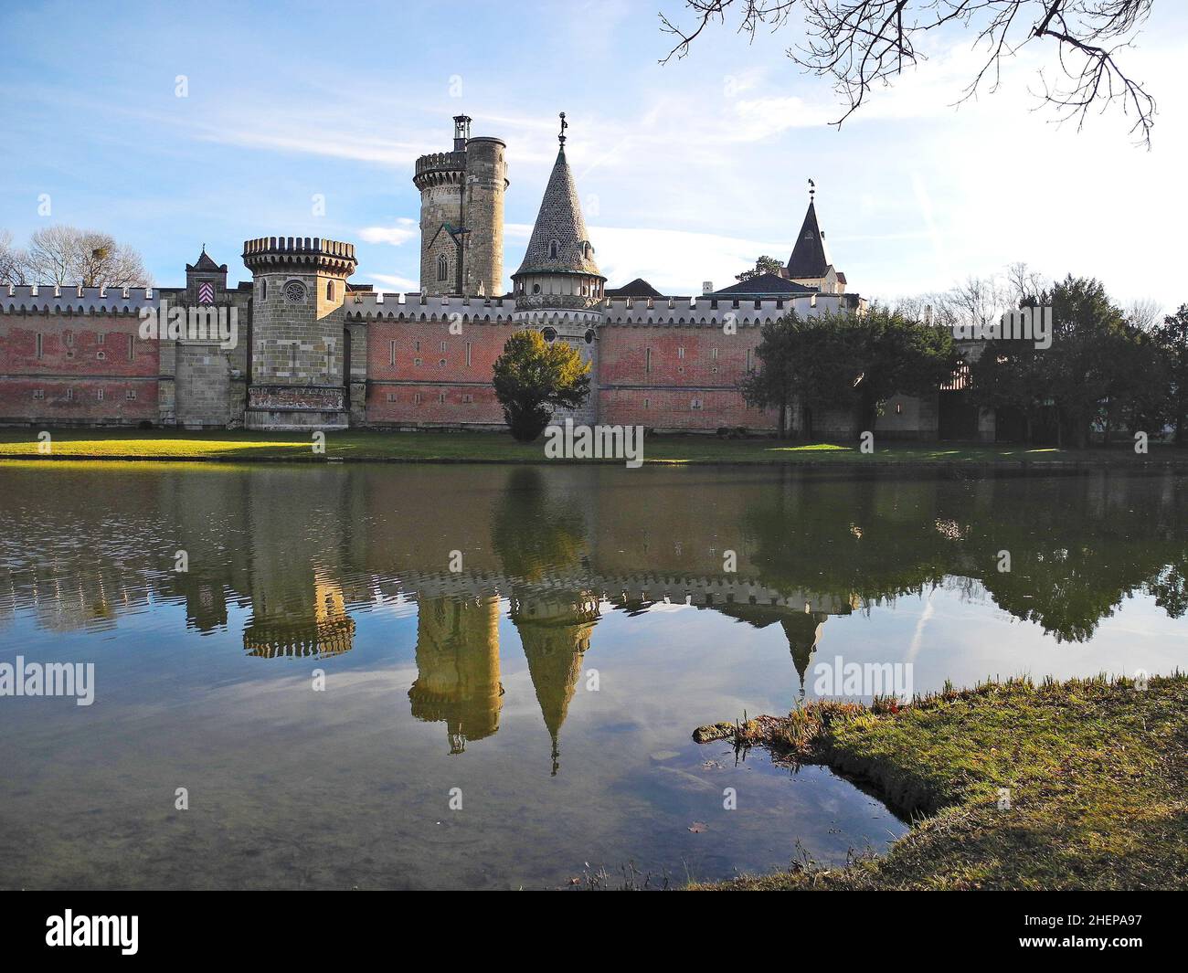 Laxenburg, Austria - January 02, 2022: Reflection of Franzensburg Castle in the lake of public castle park, a preferred destination near Vienna Stock Photo