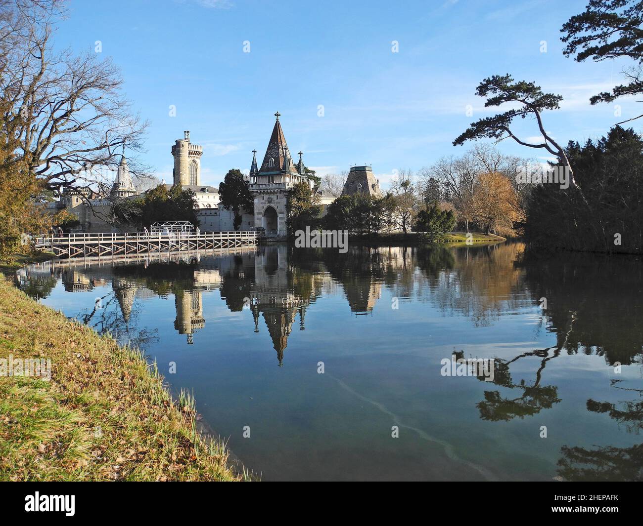 Laxenburg, Austria - January 02, 2022: Castle pond with a walkway for visitors to Franzensburg Castle, a small ferry operates in the warmer months. Th Stock Photo