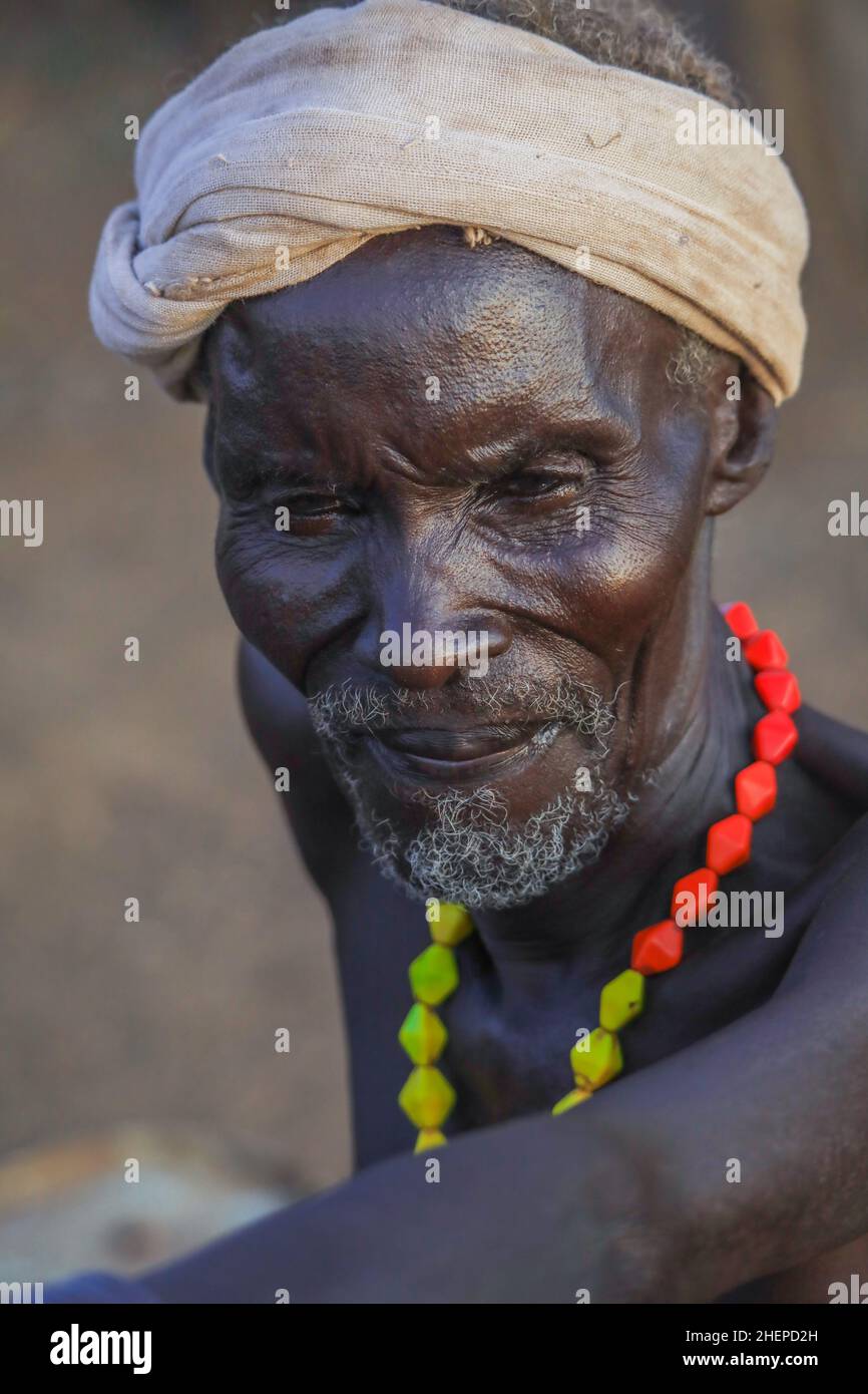 Dassanech Tribe Old Man with Traditional Bright Necklace and White Turban in the Local Village Stock Photo