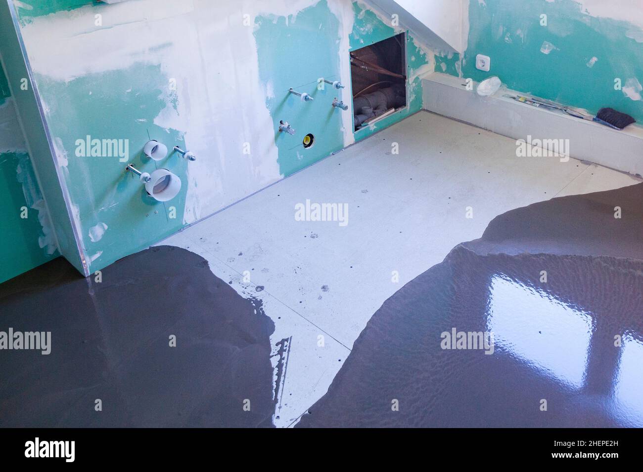 dry plaster wall in bathroom with sanitary installations Stock Photo