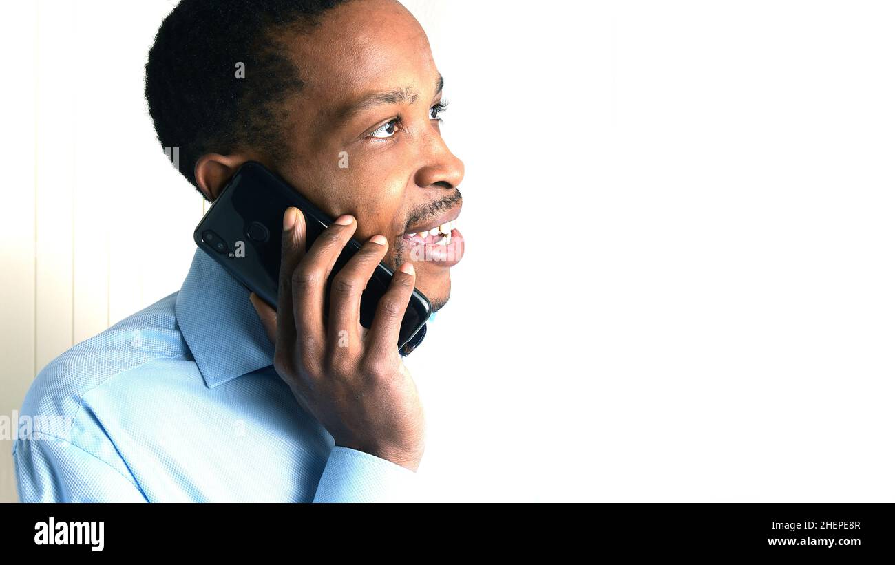 man talking on mobile telephone with neutral background Stock Photo