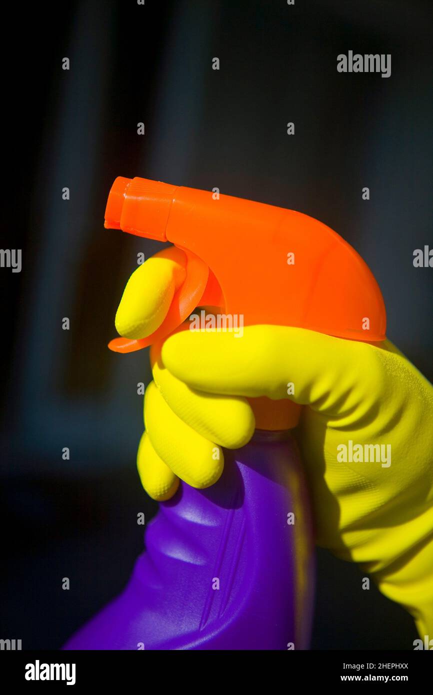 cleaning, hand in yellow rubber glove with a colorful cleaning agent