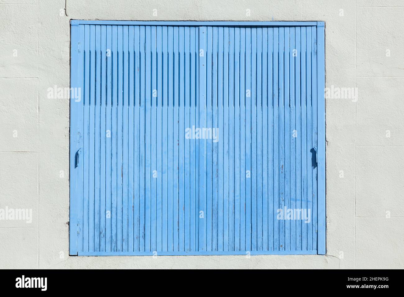 old house with wooden window shutter and peeling paint as background ...