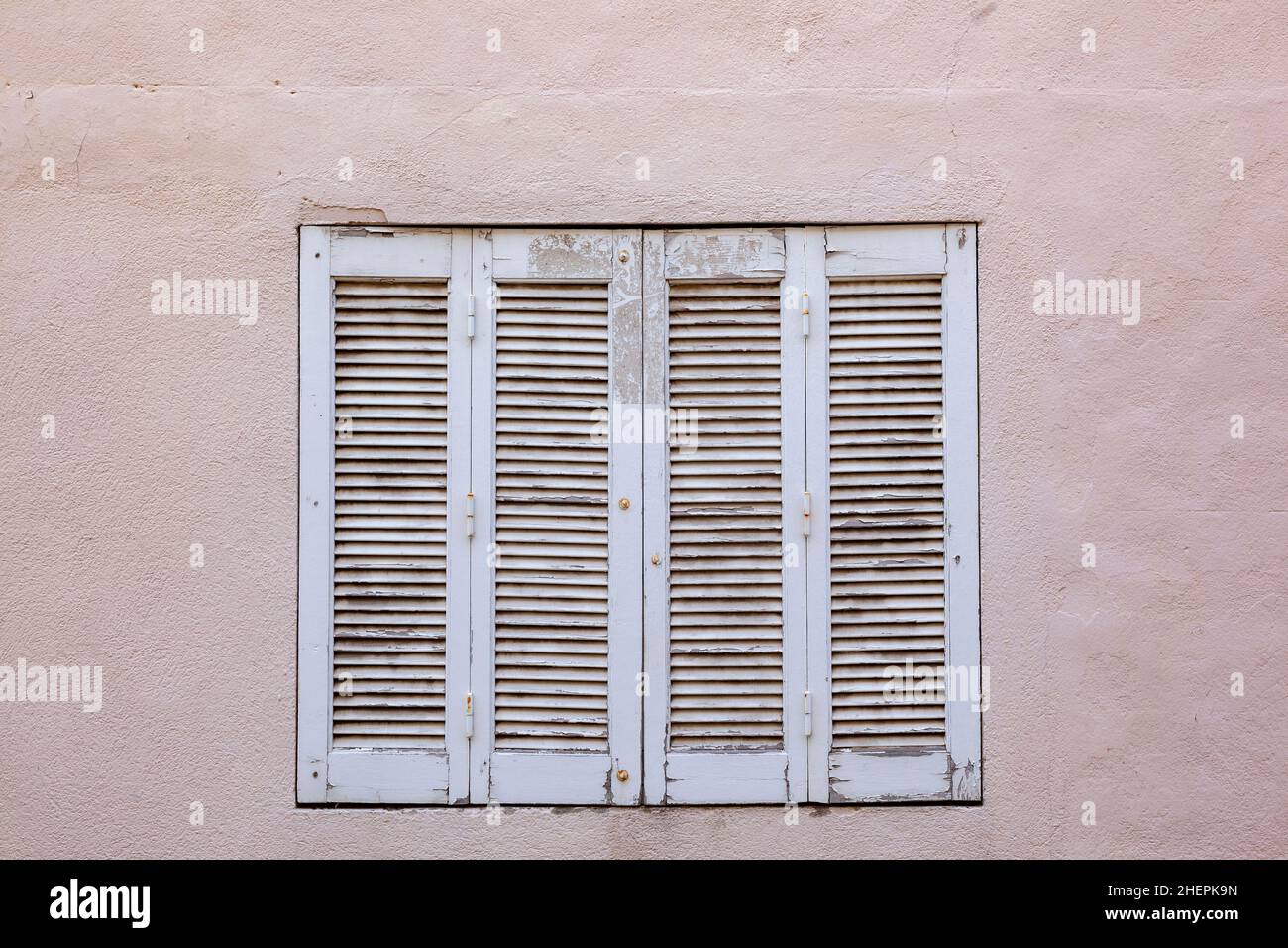 old house with wooden window shutter and peeling paint as background ...