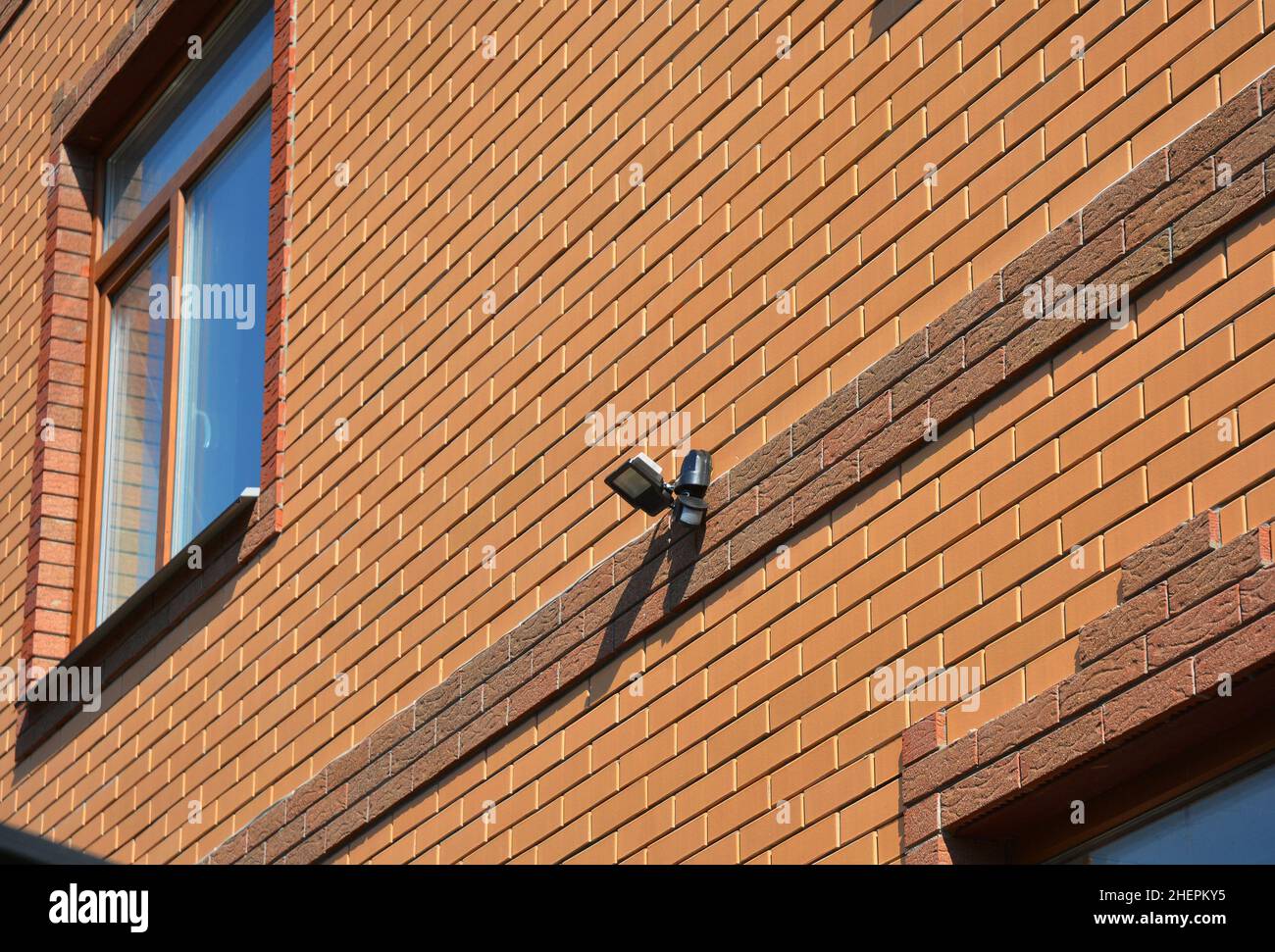 Motion Flood LED Light on House Brick Wall Outdoor. How to Choose and