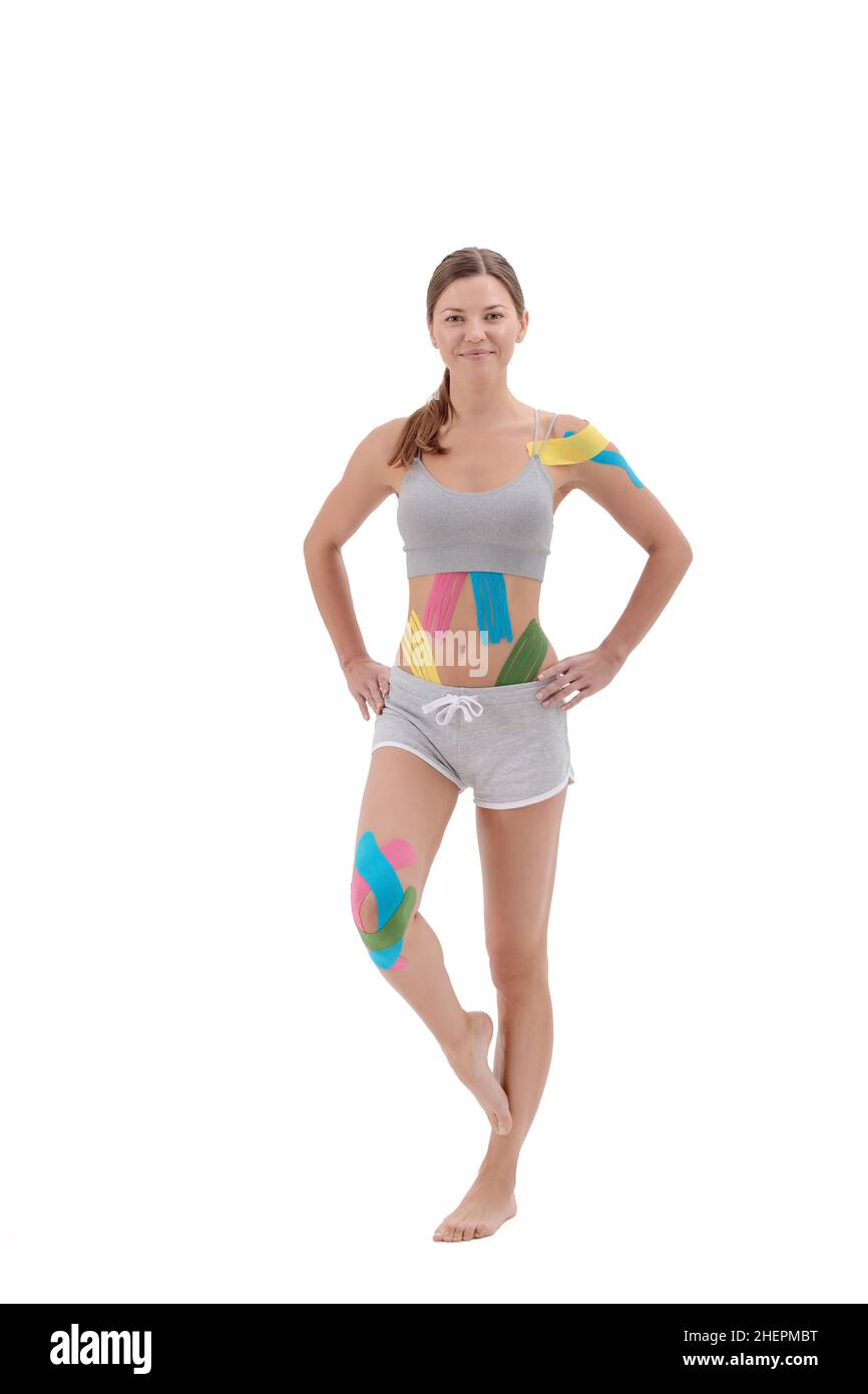 Kinesiology taping. Young female athlete on white background with