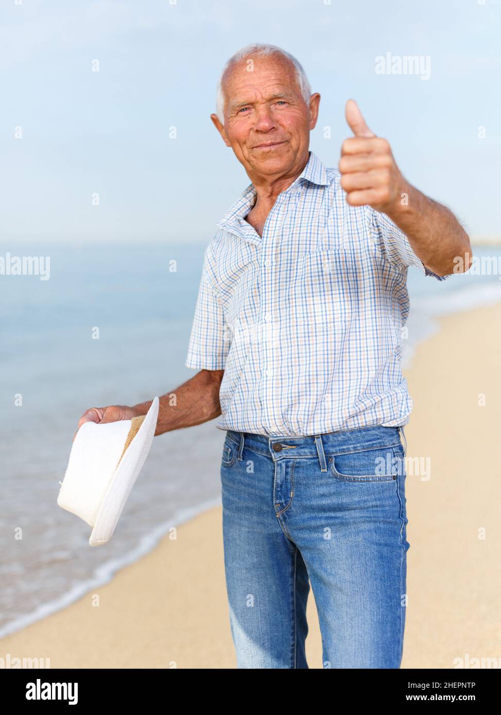 Satisfied elderly man giving thumbs up Stock Photo - Alamy