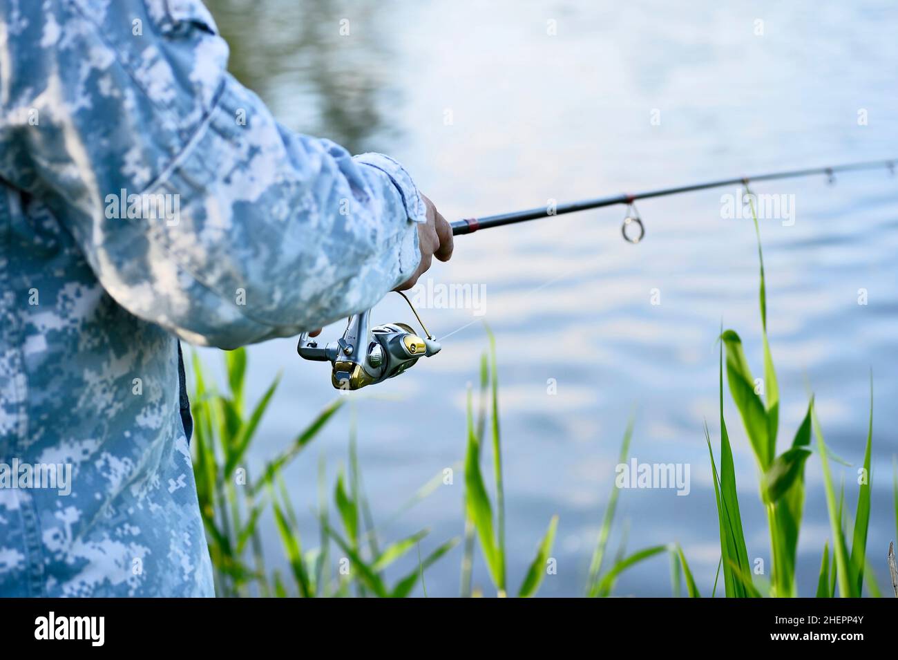 Fisherman catching predatory fish spinning in the summer. Rear and side  view of the fishing reel in close-up. Background Stock Photo - Alamy