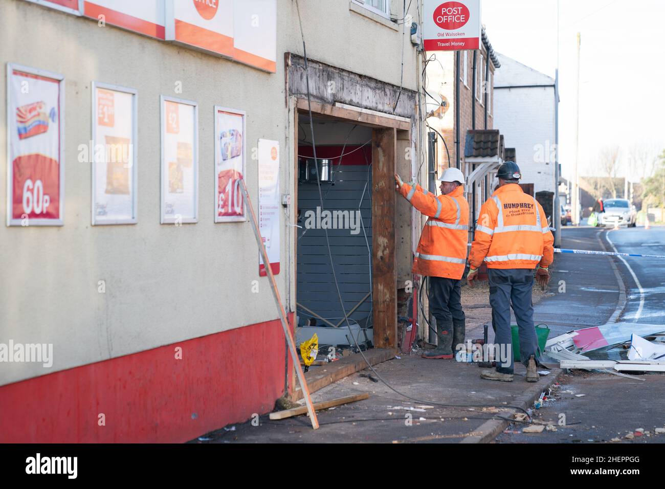 The scene at Walsoken Post Office in Wisbech, Cambridgeshire, after thieves broke in using a JCB low loader and made off with the cash machine in the early hours of the morning. Cambridgeshire Police believe that the incident is linked to another ATM theft in Yaxley last night and similar incidents in Chatteris and Cambridge last week. Picture date: Wednesday January 12, 2022. Stock Photo