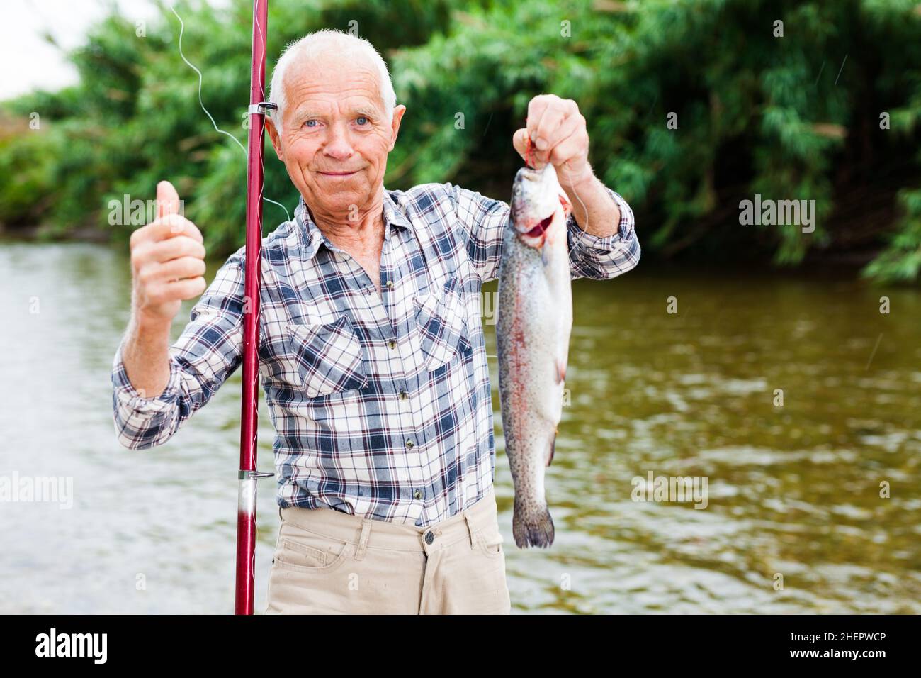 Elderly fisherman holding fish hi-res stock photography and images - Alamy