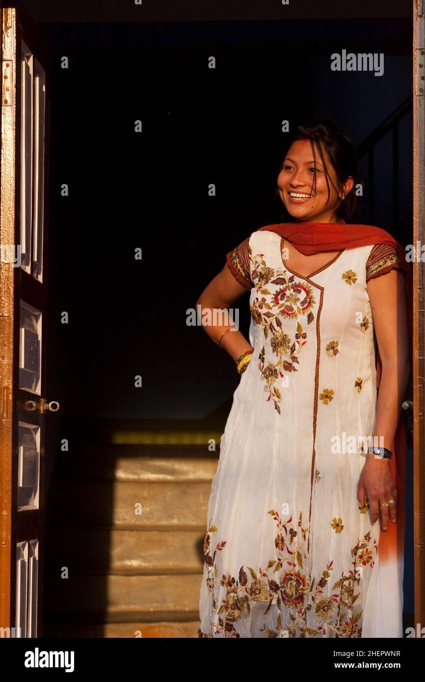 Doorway portrait of local woman during Sindoor Jatra (Vermillion Festival) - part of Nepali New Year (Bisket Jatra) in Bhaktapur. Stock Photo