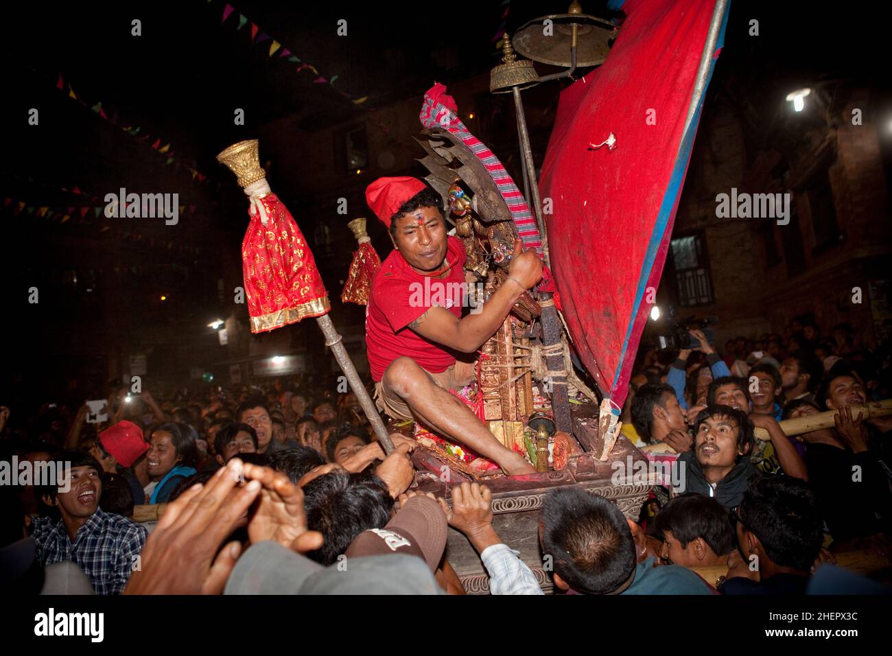 Palanquin bearers rush forth amid chaotic scenes at Bisket Jatra (Nepali New Year festival) in the UNESCO World Heritage city of Bhaktapur, Nepal. Stock Photo