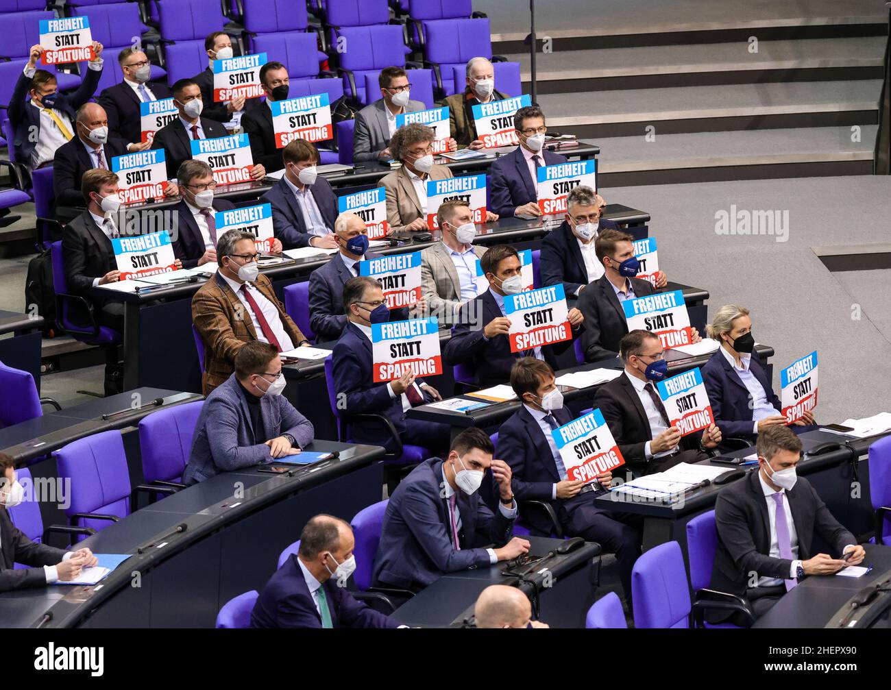 Members of the Alternative For Germany (AFD) party faction hold banners reading 'Freedom Instead of Division' as German Chancellor Olaf Scholz (SPD) speaks during a Government questioning session at Germany's lower house of parliament, the Bundestag, in Berlin, Germany, January 12, 2022.  The session provides an opportunity for the different parliament groups members to direct questions towards representatives of the German federal government. (Photo by Omer Messinger) Stock Photo