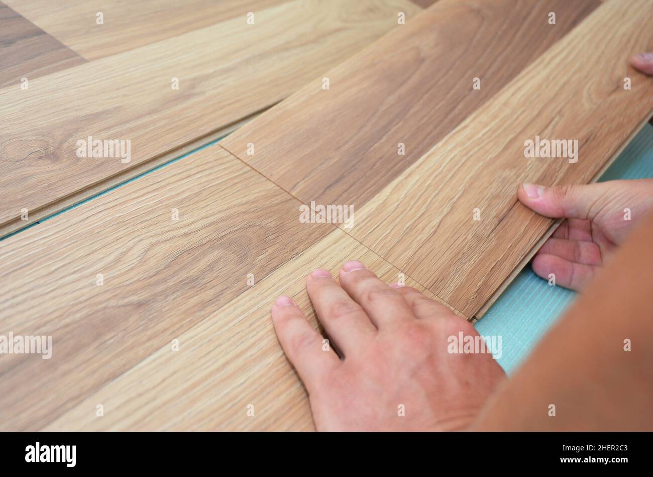 Installing laminate flooring fitting the next piece Stock Photo Alamy