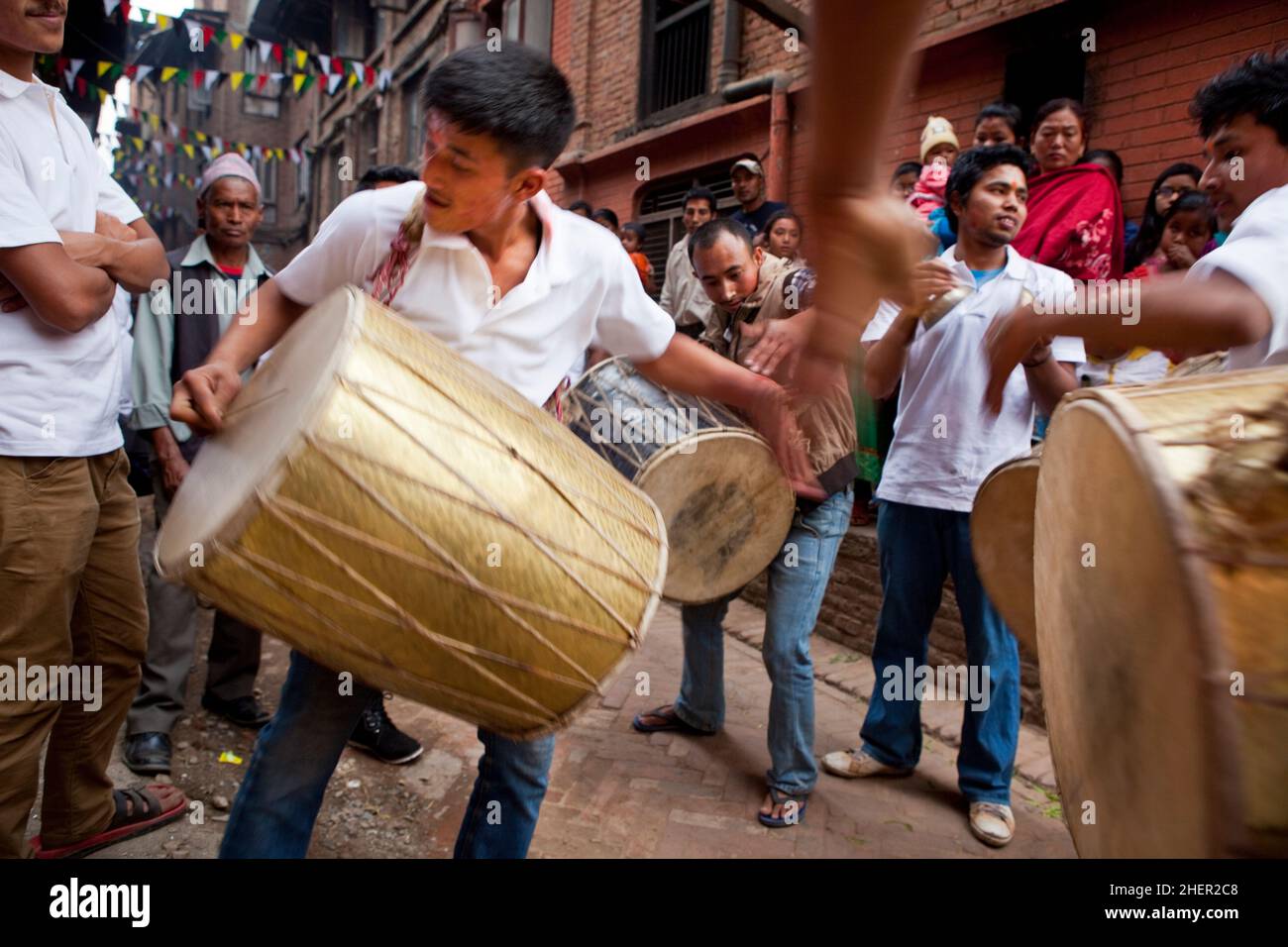 Adolescent drumming group performing during Nepali New Year (Bisket Jatra) festivities in the UNESCO World Heritage city of Bhaktapur. Stock Photo