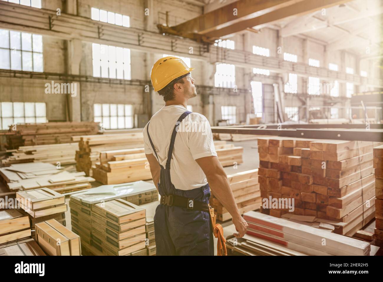 Male worker standing by construction materials in building Stock Photo