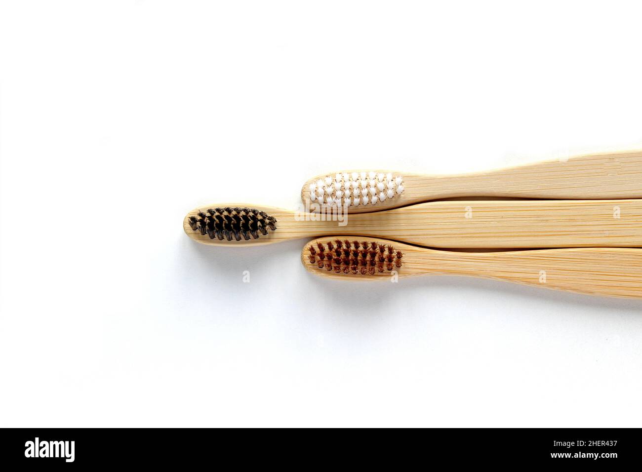 Eco-friendly bamboo toothbrushes on white background. Natural organic bathroom beauty product concept. Flat lay, top view, copy space Stock Photo