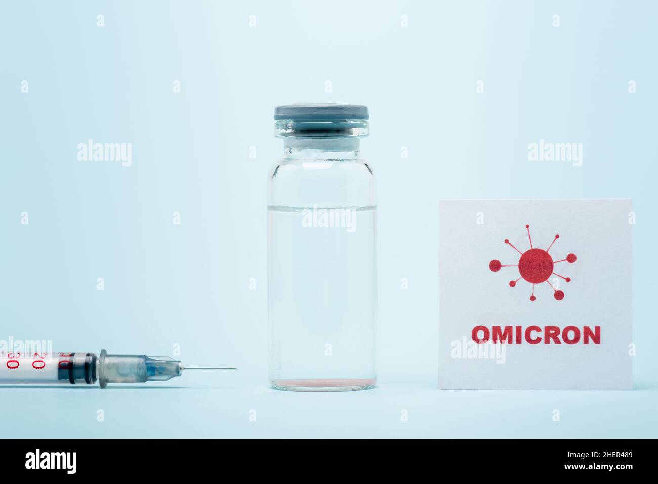syringe, vaccine vial and card with omicron lettering and bacteria icon ...