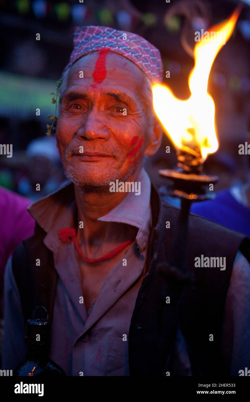 A torch bearer during Brahmayani Jatra in Bhaktapur's Dattatreya Square