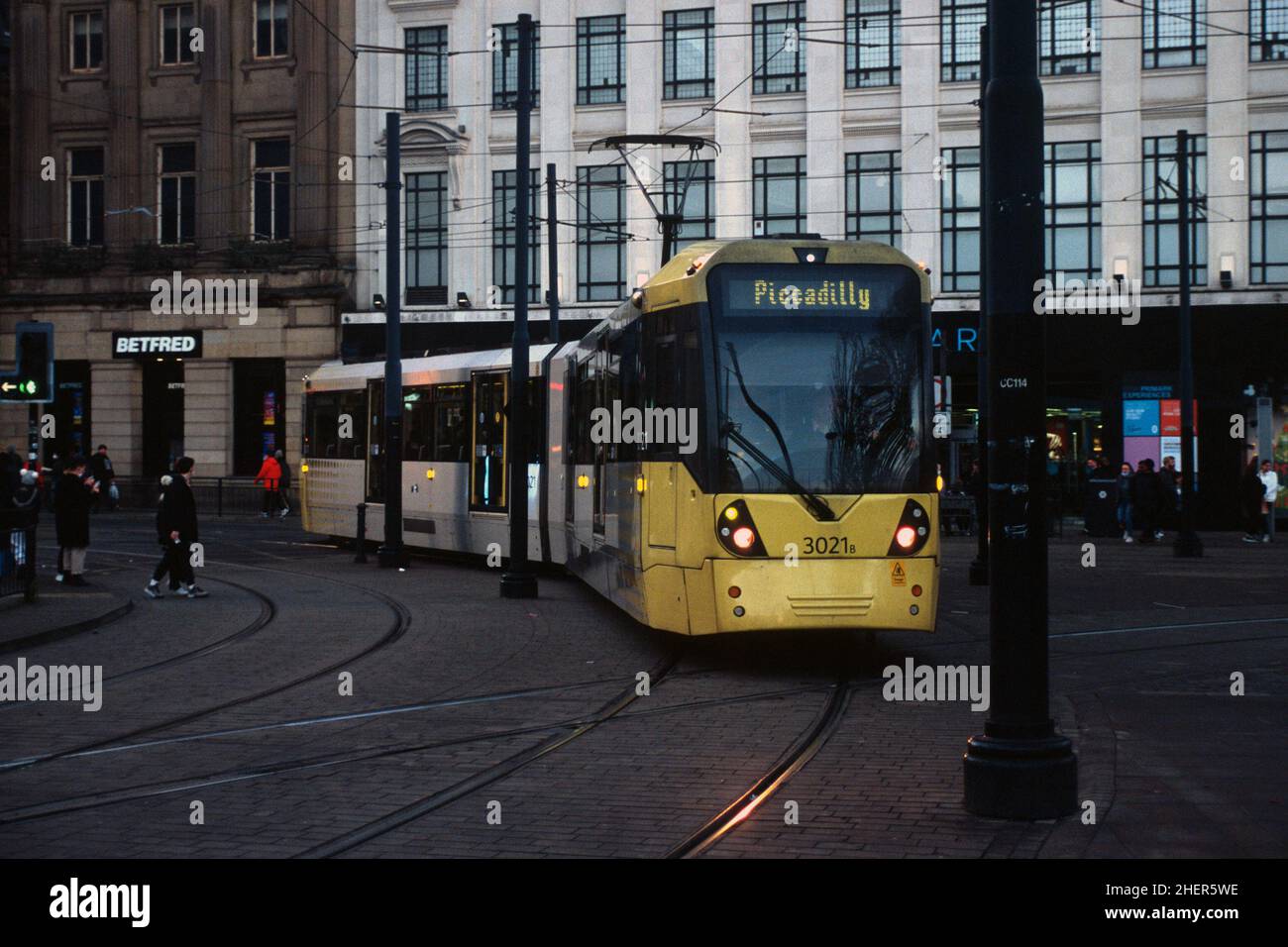 Manchester, UK - December 2021: A Metrolink tram (Bombardier M5000, no. 3021) through the junction near Piccadilly Gardens. Stock Photo