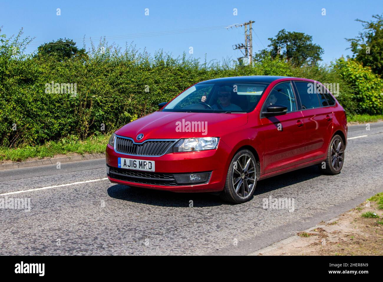 2016 red Skoda Rapid 1598cc diesel 5 speed manual en-route to Capesthorne Hall classic July car show, Cheshire, UK Stock Photo