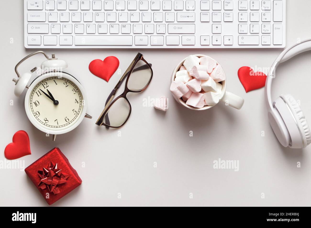 Desktop for valentine's day. Keyboard gift marshmallow on a gray table. Stock Photo