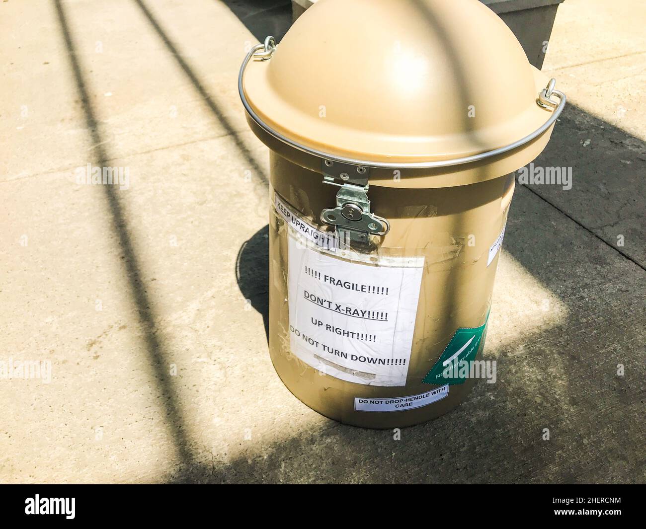 Giant isolated Sperm container with warning signs. Freezing and storage donor sperm for safe transfer concept. Stock Photo