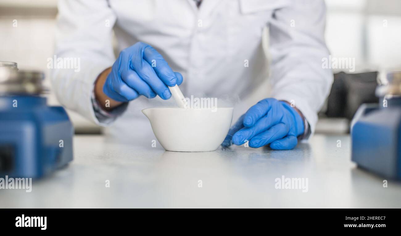 Chemist performs an experiment with liquid nitrogen in laboratory