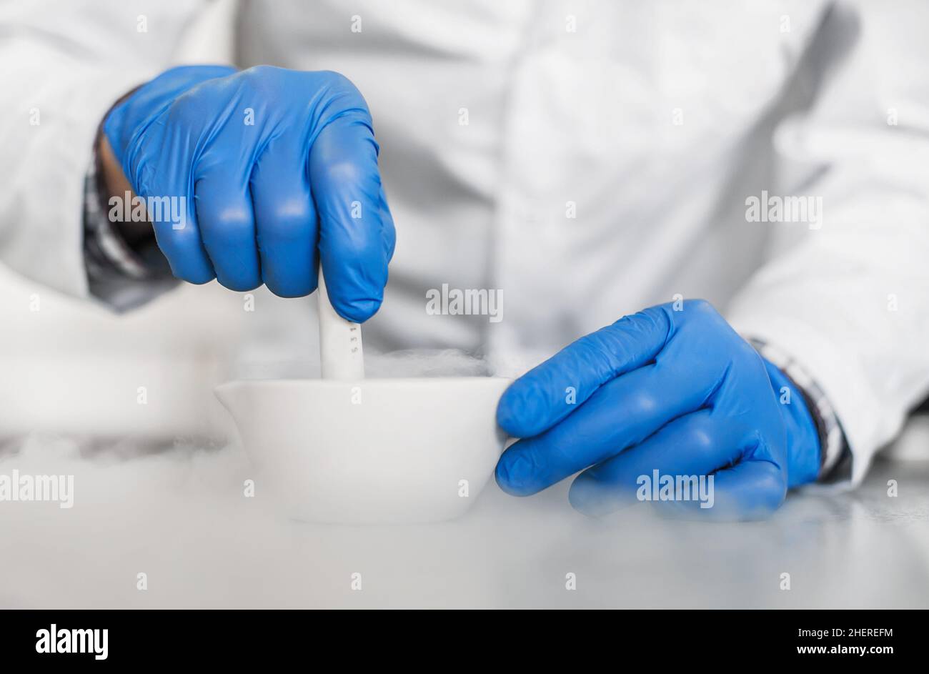 Chemist performs an experiment with liquid nitrogen in laboratory