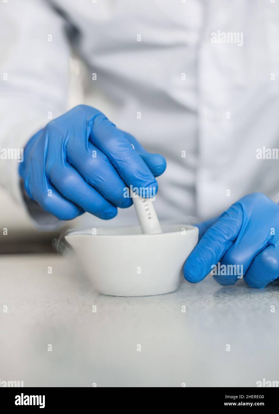 Chemist performs an experiment with liquid nitrogen in laboratory