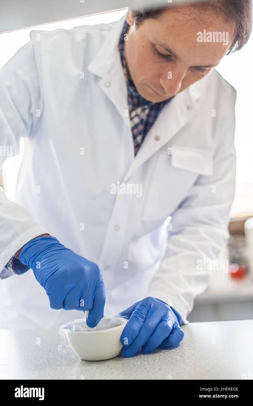 Chemist performs an experiment with liquid nitrogen in laboratory