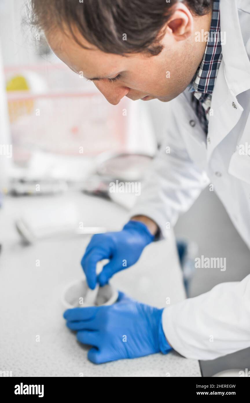 Chemist performs an experiment with liquid nitrogen in laboratory
