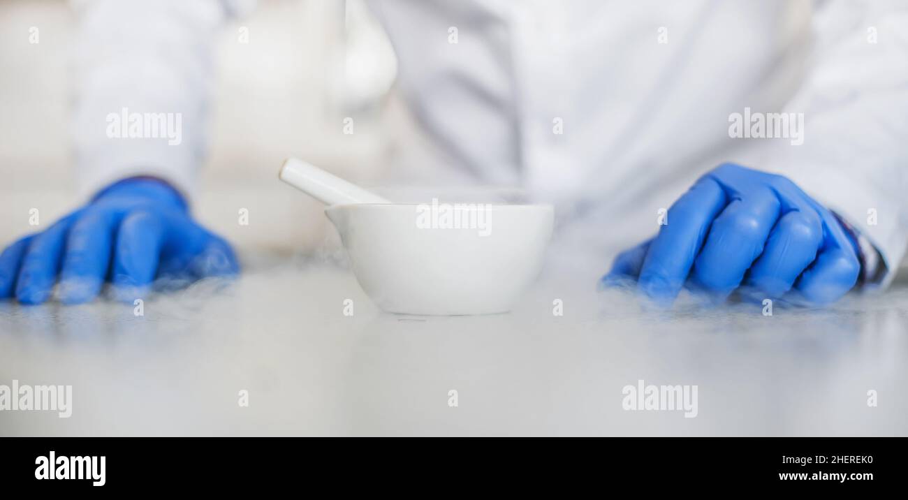 Chemist performs an experiment with liquid nitrogen in laboratory