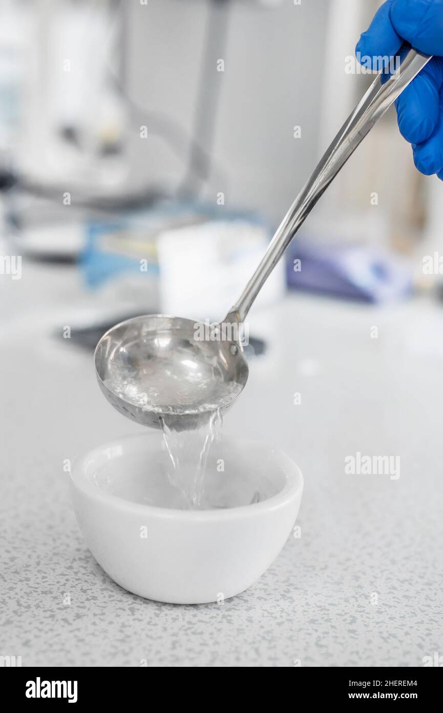 Laboratory technician performs an experiment with liquid nitrogen in