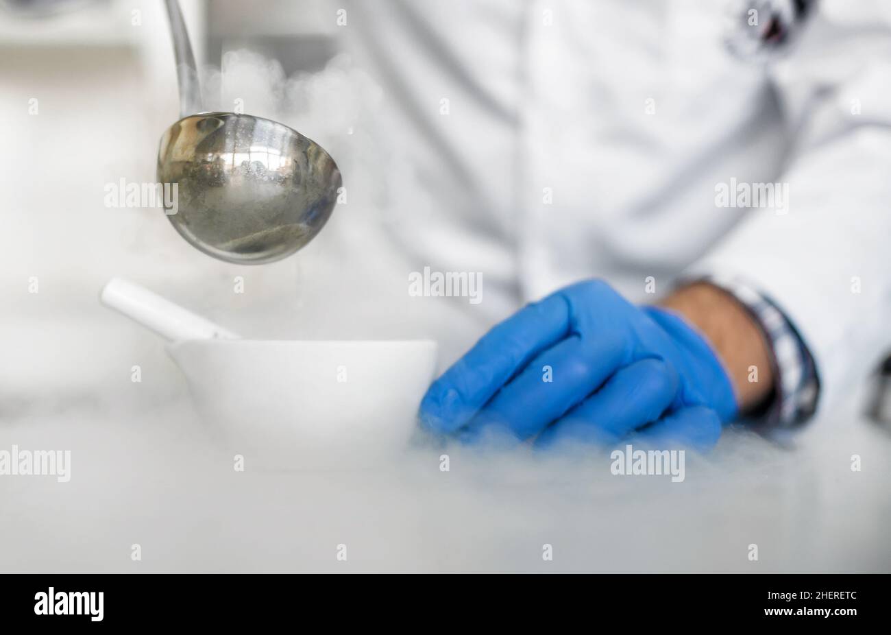Laboratory technician performs an experiment with liquid nitrogen in