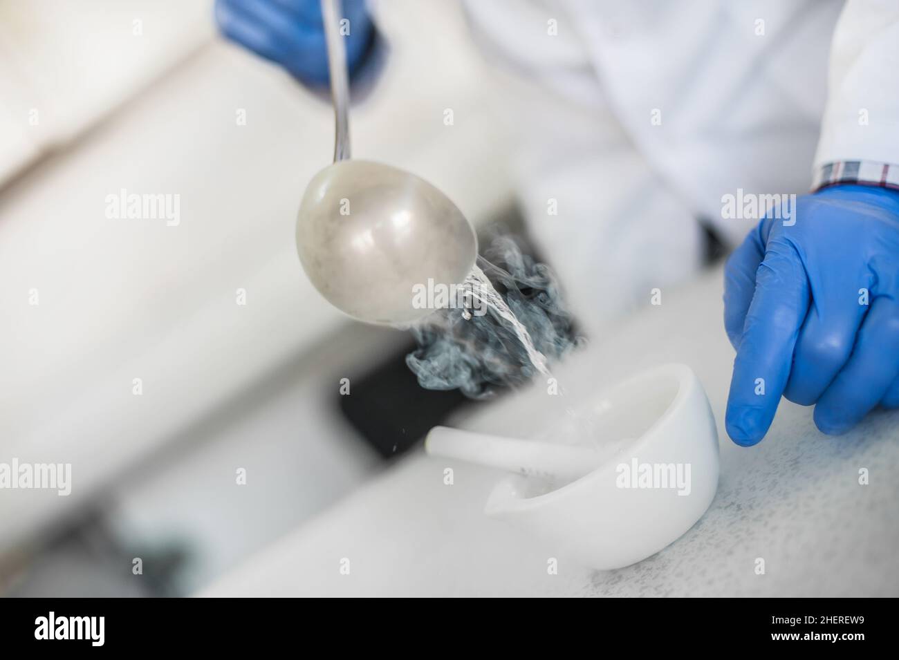 Laboratory technician performs an experiment with liquid nitrogen in