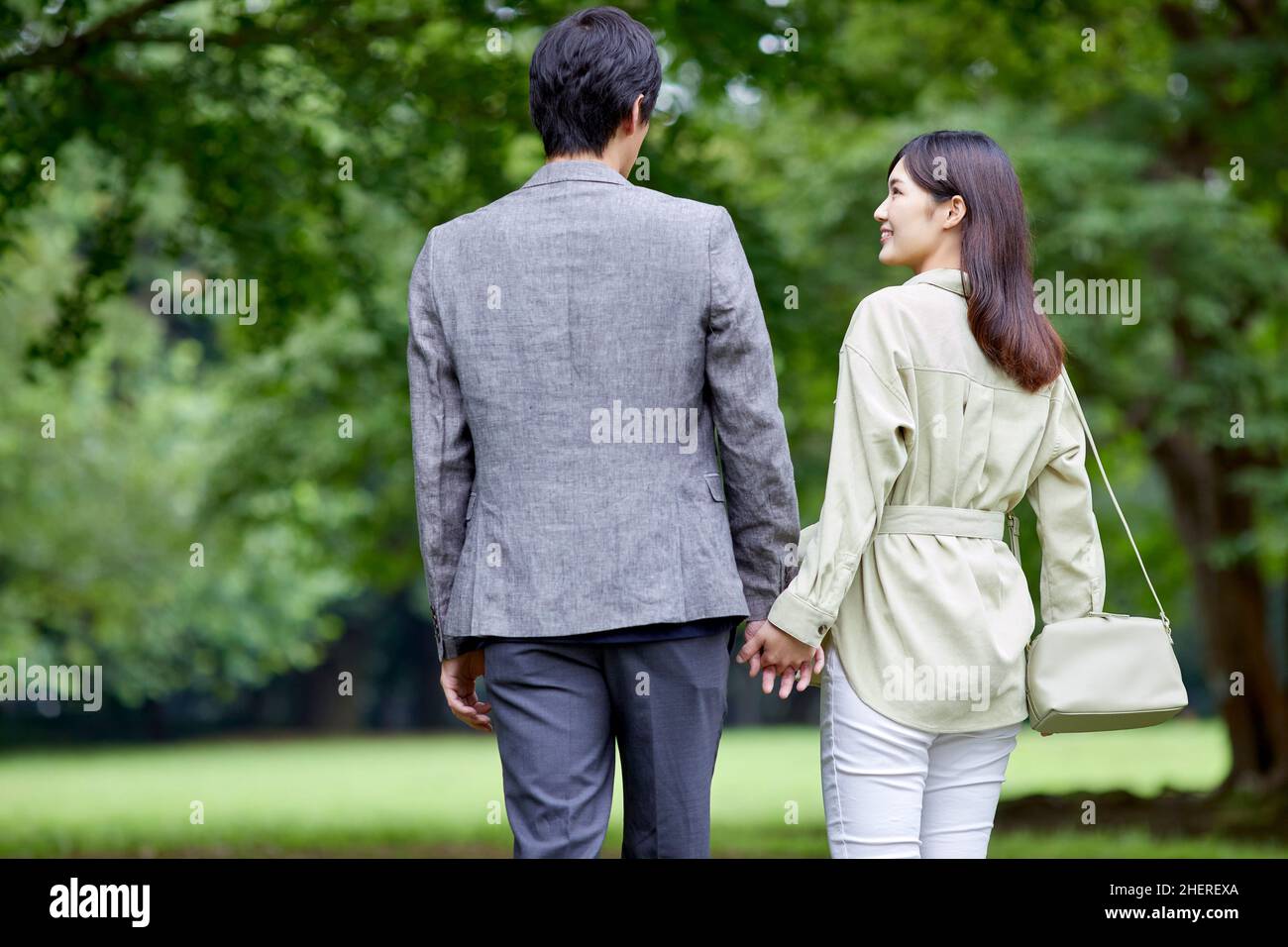 Asian couple holding hands taking hi-res stock photography and images ...