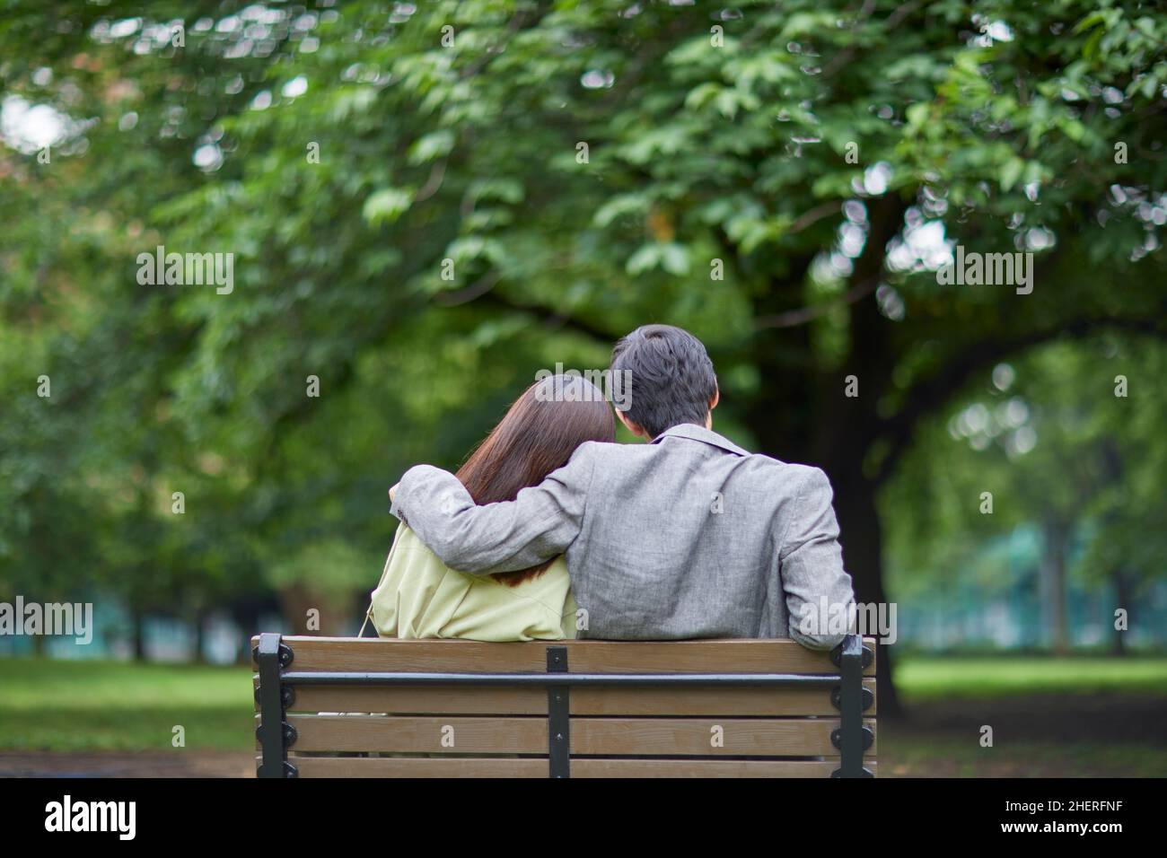 Japanese Couple Sitting On The Bench Stock Photo - Alamy