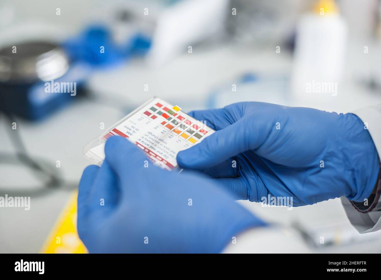 Laboratory technician working with test strips indicator paper in the