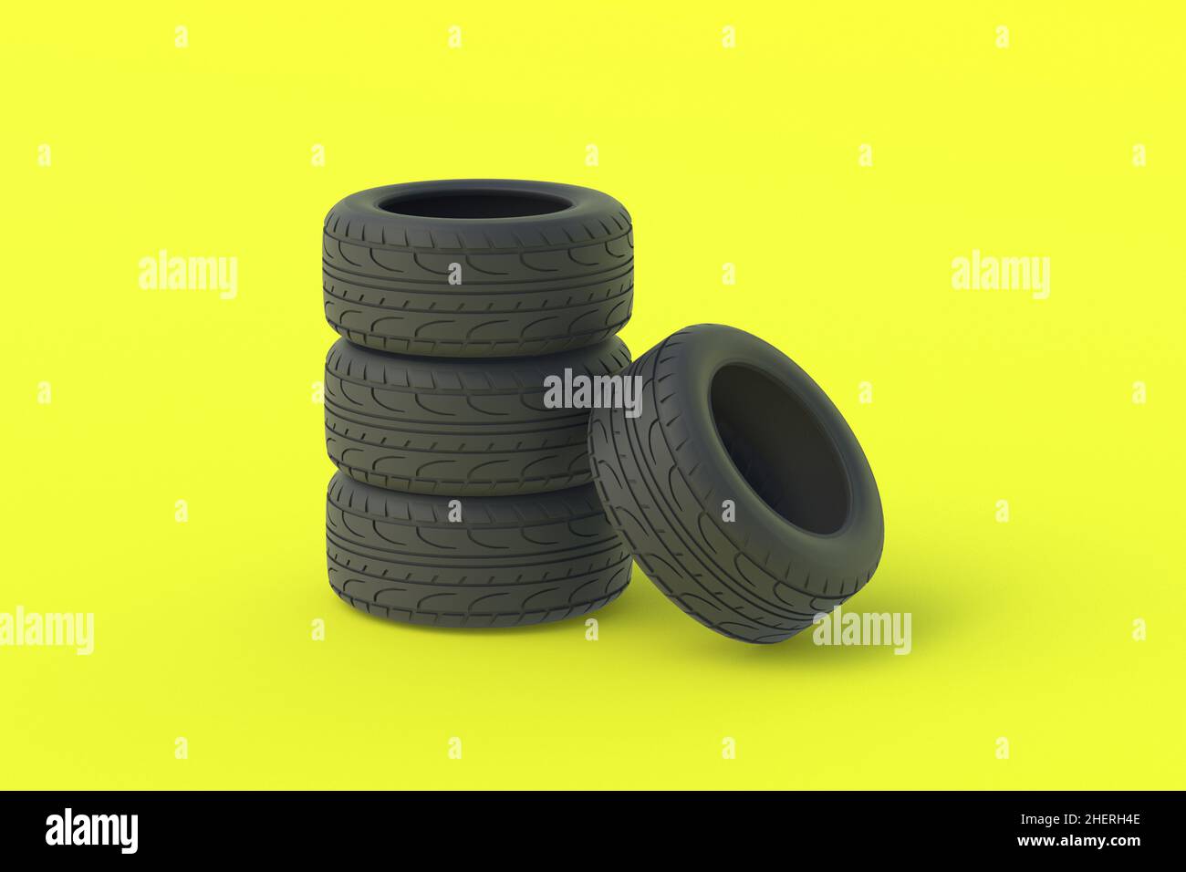 Heap of car rubber tyres on yellow background. Automotive parts